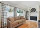 Bright living room with hardwood floors, fireplace, and sliding door access to the backyard at 7255 S Vine St, Centennial, CO 80122