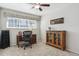 Charming home office features a ceiling fan, bright window, neutral walls, and vintage wood accents at 7255 S Vine St, Centennial, CO 80122