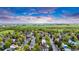 An aerial view of the property in a lush green neighborhood with blue skies at 323 S Hoover Ave, Louisville, CO 80027