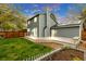 A spacious backyard with a well-maintained lawn, white picket fence and large deck at 323 S Hoover Ave, Louisville, CO 80027