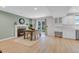 Spacious dining area with a fireplace, adjacent to a sliding glass door and white kitchen cabinets at 323 S Hoover Ave, Louisville, CO 80027