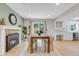 Well-lit dining area with a fireplace, large table and slider door with adjacent kitchen area at 323 S Hoover Ave, Louisville, CO 80027