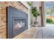 Inviting living room fireplace with stone surround, black insert, and views of the backyard at 323 S Hoover Ave, Louisville, CO 80027