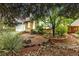 Landscaped front yard with rock features, brick accents and a large tree providing plenty of shade at 323 S Hoover Ave, Louisville, CO 80027