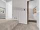 Hallway leads to multiple rooms with neutral paint and carpeted floors at 323 S Hoover Ave, Louisville, CO 80027