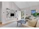 Bright and airy living room with large shelving feature, sofa and coffee table at 323 S Hoover Ave, Louisville, CO 80027