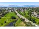 Enjoy this serene aerial view of lush green spaces with picturesque mountain views in the distance at 1040 Hemlock Way, Broomfield, CO 80020