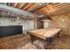 Basement with a pool table, bar, and unique wood paneled accent wall at 1040 Hemlock Way, Broomfield, CO 80020