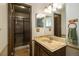 Updated bathroom with a glass-enclosed shower, marble sink, and warm wood accents at 1040 Hemlock Way, Broomfield, CO 80020
