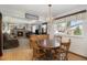 Inviting dining area with wood table, a window view, and seamless transition to a cozy living room with a fireplace at 1040 Hemlock Way, Broomfield, CO 80020