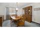 Elegant dining room with a large wooden table and display cabinet, perfect for Gathering meals at 1040 Hemlock Way, Broomfield, CO 80020