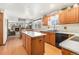 Open-concept kitchen with an island, modern appliances, and view to the living room, great for entertaining at 1040 Hemlock Way, Broomfield, CO 80020