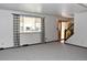 Bright living room with large window, neutral carpet, and entry view at 1040 Hemlock Way, Broomfield, CO 80020