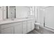 Modern bathroom with double vanity, sleek white cabinets, and a glass-enclosed shower at 24747 E 40Th Ave, Aurora, CO 80019