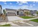 Lovely single-Gathering home featuring stone accents, a two-car garage, and a well-manicured lawn at 24747 E 40Th Ave, Aurora, CO 80019