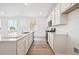 An open-concept kitchen boasts modern amenities including stainless appliances and a central island for cooking and entertaining at 24747 E 40Th Ave, Aurora, CO 80019