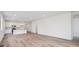 Bright, open-concept living room and kitchen with modern white cabinets and beautiful hardwood floors at 24747 E 40Th Ave, Aurora, CO 80019