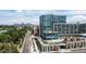 Stunning aerial view of a modern condo complex with a rooftop pool and city skyline backdrop at 4200 W 17Th Ave # 619, Denver, CO 80204