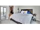 Bedroom with a queen bed, large mirror, a glimpse into the spacious walk-in closet at 4200 W 17Th Ave # 619, Denver, CO 80204