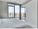 Bright bedroom offering abundant natural light and city views from the floor-to-ceiling windows at 4200 W 17Th Ave # 619, Denver, CO 80204