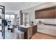 Open-concept kitchen with large island, stainless steel appliances, and lots of natural light at 4200 W 17Th Ave # 619, Denver, CO 80204
