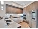 Modern kitchen featuring sleek cabinets, stainless steel appliances, and stylish lighting at 4200 W 17Th Ave # 619, Denver, CO 80204