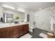 Modern bathroom with double sinks, sleek cabinets, stylish fixtures, and a glass-enclosed shower at 47 Harrison, Denver, CO 80206