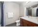 Cozy bathroom with modern fixtures, a tiled shower with curtain, and a sleek vanity at 47 Harrison, Denver, CO 80206