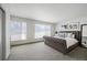 Relaxing bedroom featuring a large bed, soft carpet, and windows with plenty of natural light at 47 Harrison, Denver, CO 80206