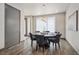 Dining room features a modern light fixture, a round table, and large window at 47 Harrison, Denver, CO 80206