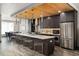 Modern kitchen boasts stainless steel appliances, a large island with seating, and a beautiful dining area at 47 Harrison, Denver, CO 80206