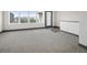 Bright living room with carpet, large windows, and a doorway with nice trim details at 47 Harrison, Denver, CO 80206