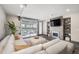 Comfortable living room with fireplace, flatscreen TV, and sliding garage door to a covered patio at 47 Harrison, Denver, CO 80206