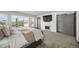 A spacious bedroom with a TV over a fireplace, offering both comfort and style at 47 Harrison, Denver, CO 80206