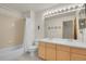 Bathroom featuring a tub/shower combination, double sink vanity, large mirror, and neutral finishes at 31139 Tahoe Ct, Evergreen, CO 80439