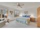Comfortable bedroom featuring a ceiling fan, large windows, and neutral-colored walls and carpet at 31139 Tahoe Ct, Evergreen, CO 80439