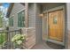 Charming front door with sidelight window and craftsman details, set on a covered porch at 31139 Tahoe Ct, Evergreen, CO 80439