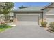 Exterior view of a two-car garage with stone accents and a paved driveway, offering convenience and curb appeal at 31139 Tahoe Ct, Evergreen, CO 80439