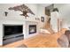 Inviting living room with a decorative fireplace, mounted TV, and a staircase at 31139 Tahoe Ct, Evergreen, CO 80439