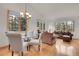 Elegant living room with hardwood floors, a chandelier, and large windows offering natural light at 31139 Tahoe Ct, Evergreen, CO 80439