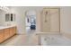 Spacious main bathroom with a soaking tub, glass shower, double sink vanity, and neutral finishes at 31139 Tahoe Ct, Evergreen, CO 80439