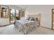 Bright main bedroom with large windows, a sliding glass door, and a comfortable king-size bed at 31139 Tahoe Ct, Evergreen, CO 80439