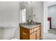 Powder room featuring a glass vessel sink with wood cabinets at 12317 W Gould Ave, Littleton, CO 80127
