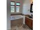 Bathroom with a soaking tub, granite countertop, bowl sink, and tile flooring at 12317 W Gould Ave, Littleton, CO 80127