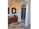 Bathroom with a walk-in shower, granite countertop, bowl sink, and tile flooring at 12317 W Gould Ave, Littleton, CO 80127