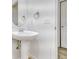 Classic bathroom with pedestal sink, framed round mirror, and neutral tones creates a calming atmosphere at 12317 W Gould Ave, Littleton, CO 80127