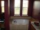 Bathroom featuring a soaking tub under two windows, next to a vanity with a wooden sink at 12317 W Gould Ave, Littleton, CO 80127