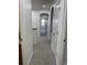 Hallway with white walls, neutral carpet, and arched entryway leading to other rooms at 12317 W Gould Ave, Littleton, CO 80127