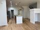 Spacious kitchen featuring island, stainless steel appliances, hardwood floors, and pantry at 12317 W Gould Ave, Littleton, CO 80127