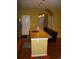 Kitchen island with granite countertop, sink, pendant lights and four bar stools at 12317 W Gould Ave, Littleton, CO 80127
